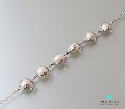 null Metal bracelet adorned with six freshwater cultured pearls, the clasp snap hook.
Length:...
