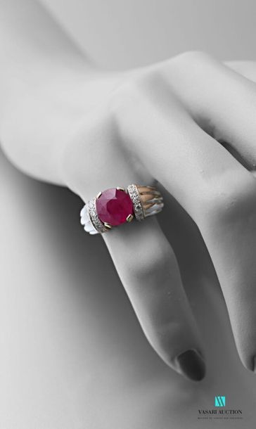 null A 750 thousandth white gold gadrooned ring set with an oval-shaped Burmese ruby...