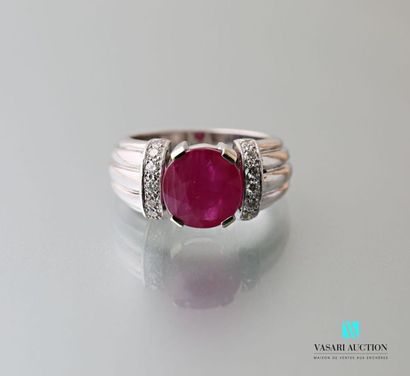 null A 750 thousandth white gold gadrooned ring set with an oval-shaped Burmese ruby...