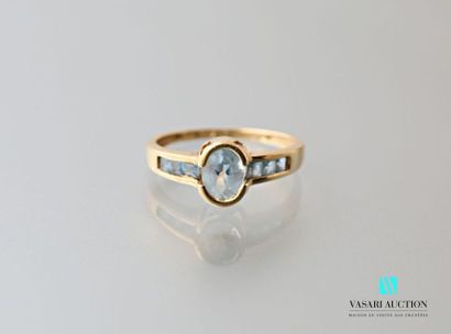 null 750 thousandths yellow gold ring adorned in its center with an oval topaz, shouldered...