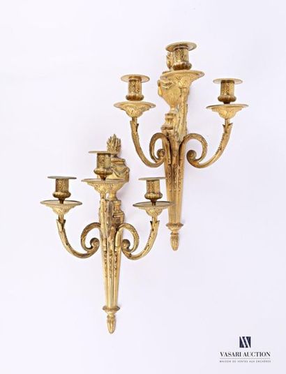 null Pair of bronze sconces, the tapered base plate decorated with roughened flutes...