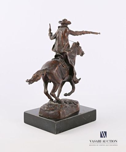 null Bronze subject with a brown patina representing a cowboy riding a horse, it...