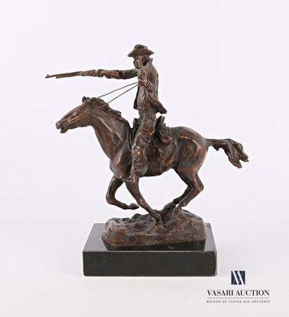 null Bronze subject with a brown patina representing a cowboy riding a horse, it...