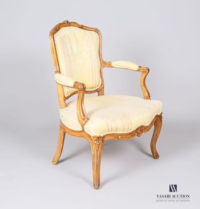 null Moulded and carved natural wood armchair, the animated backrest topped with...