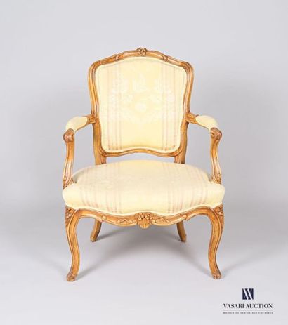 null Moulded and carved natural wood armchair, the animated backrest topped with...
