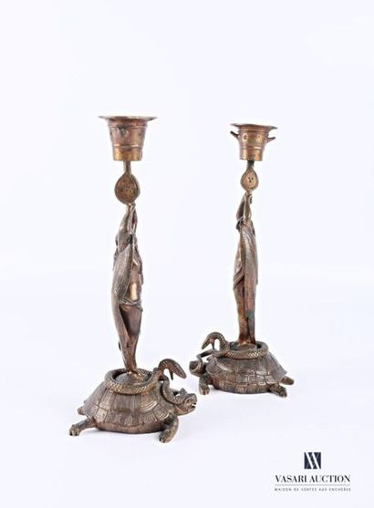 null Pair of bronze candleholders, the base depicting entwined turtles and snakes,...