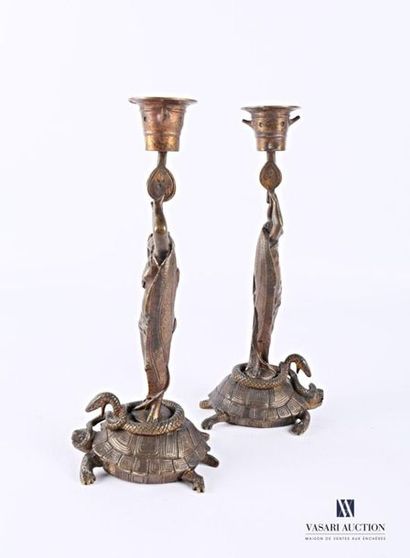 null Pair of bronze candleholders, the base depicting entwined turtles and snakes,...