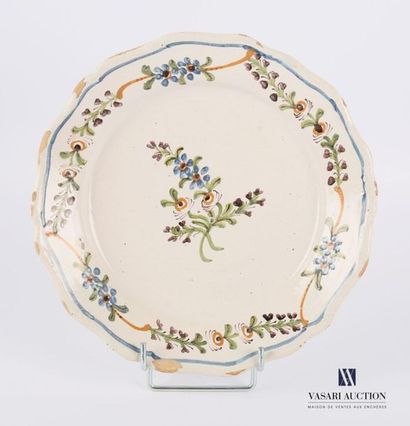 null North 18th century 
Earthenware plate with polychrome decoration in the center...