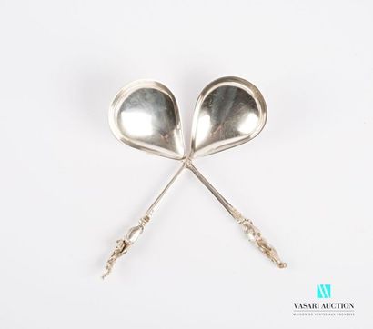 null Two silver spoons, the handle decorated with a monogrammed cartouche surmounted...