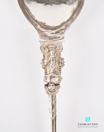 null Silver serving spoon, the handle has a bacchus resting on a mound supported...
