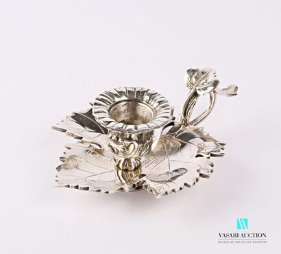 null A silver bronze candleholder in the shape of a vine leaf supporting a small...