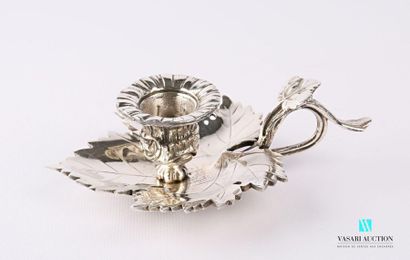 null A silver bronze candleholder in the shape of a vine leaf supporting a small...