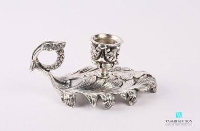 null Silver bronze hand candlestick resting on two large acanthus leaves supports...