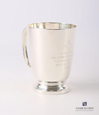 null Mug in silver plated metal in the shape of a truncated cone resting on a pedestal...