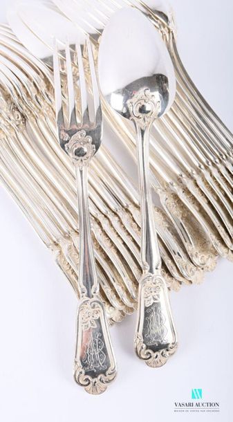 null A set of eleven pieces of cutlery and a silver table spoon, the handle decorated...