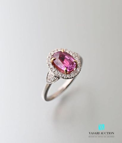 null 750 thousandths white gold ring set with a pink sapphire calibrating approximately...