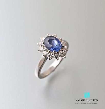 null White gold ring set with an oval-shaped sapphire calibrating approximately 1.70...