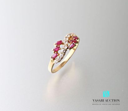null 750 thousandths yellow gold ring set with six shuttle rubies supporting an undulating...