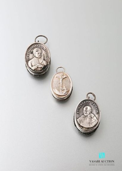 null Three oval silver reliquary pendants whose backs are decorated with representations...