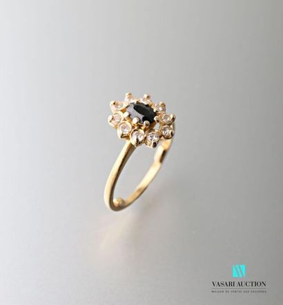 null 750 thousandths yellow gold ring set with a central sapphire surrounded by ten...