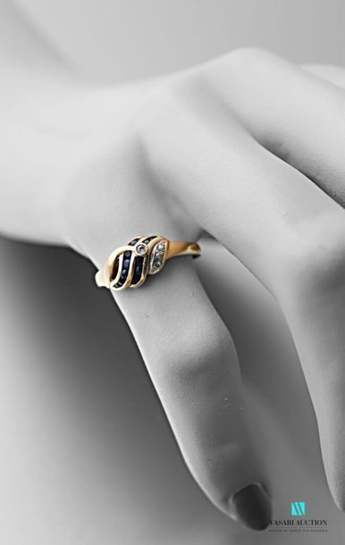 null Yellow gold ring 750 thousandths twisted shape decorated with three small diamonds...