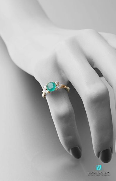 null 750 thousandths yellow gold ring set with a central square-cut emerald with...