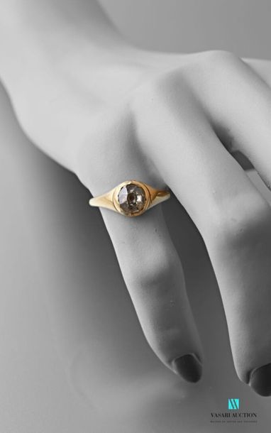 null 750 thousandths yellow gold ring set with an antique cut diamond of about 0.90...