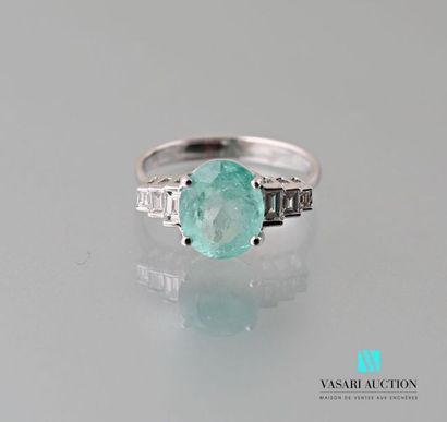 null 750 thousandths white gold ring set with an oval-cut emerald of approximately...