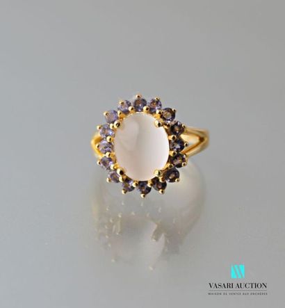 null Gilt vermeil ring centred on a cabochon cut moonstone hemmed with round cut...