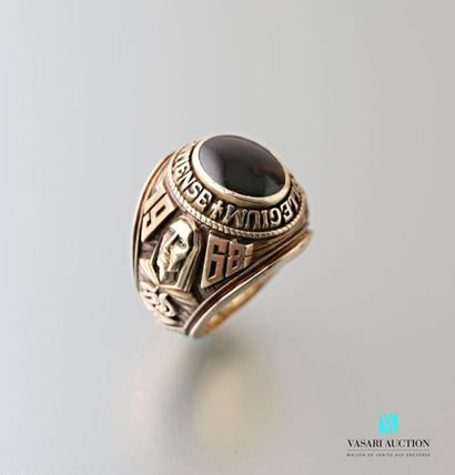 null 9 karat gold university ring set with a cabochon onyx surrounded by the inscription...