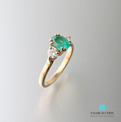null 750 thousandths yellow gold ring set with a central oval emerald with two 0.20...