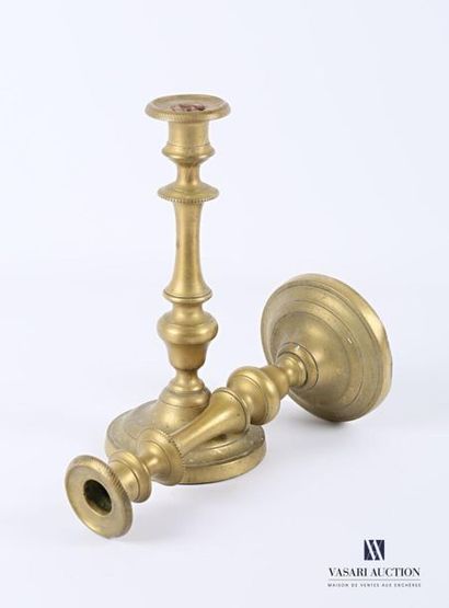 Pair of brass candleholders resting on a...