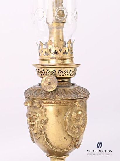 null Bronze oil lamp, the baluster-shaped tank decorated with masks of grimaceous...