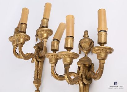 null Pair of bronze sconces with three light arms, the shaft decorated with garlands...