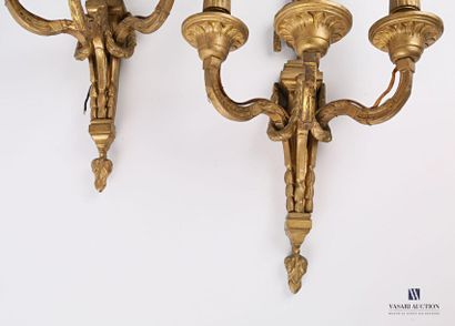 null Pair of bronze sconces with three light arms, the shaft decorated with garlands...