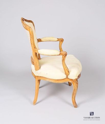 null Moulded and carved natural wood armchair, the animated backrest topped with...