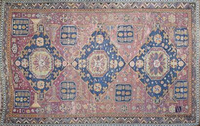 null Wool carpet decorated with three medallions centred on a stylised flower inscribed...