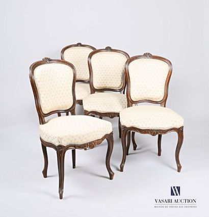 null A suite of four chairs in moulded and carved natural wood with flower decoration,...