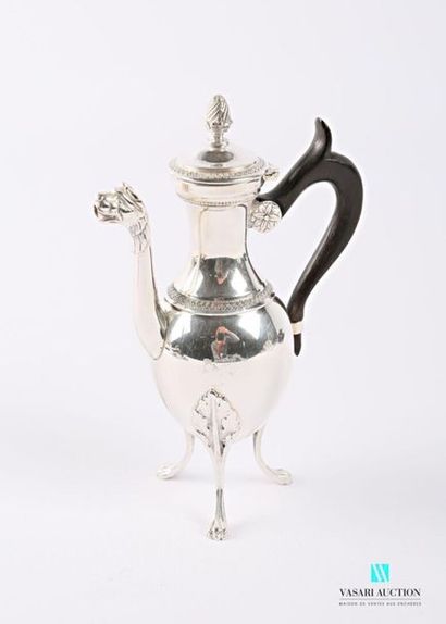 null A selfish silver jug resting on three arched feet with lion claws and leafy...