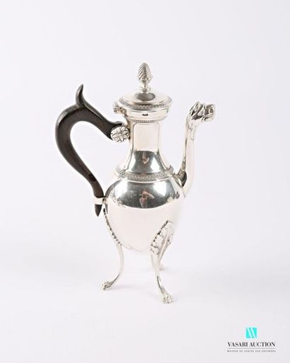 null A selfish silver jug resting on three arched feet with lion claws and leafy...