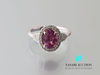 null 750 thousandths white gold ring set with a pink sapphire calibrating approximately...