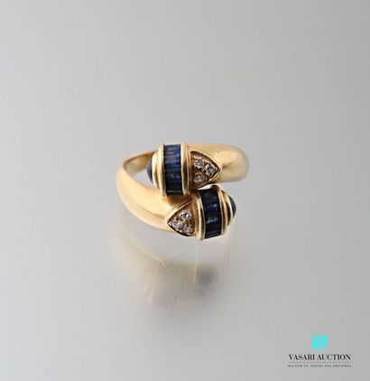 null Crossed ring in 750 thousandths yellow gold set with baguette sapphires, small...