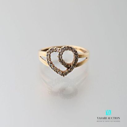 null 750 thousandths yellow gold ring featuring an openwork heart hemmed with a line...