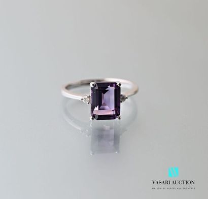 null 750 thousandths white gold ring set with an emerald-cut amethyst of approximately...