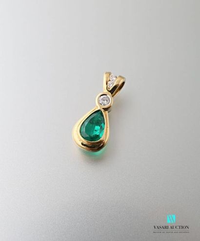 null Pendant in yellow gold 750 thousandths pear shape set with an emerald surmounted...