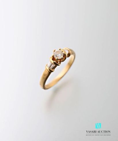 null 750 thousandths yellow gold ring set with a central brilliant of approximately...