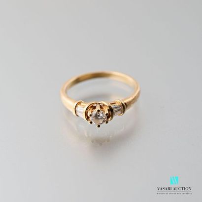 null 750 thousandths yellow gold ring set with a central brilliant of approximately...