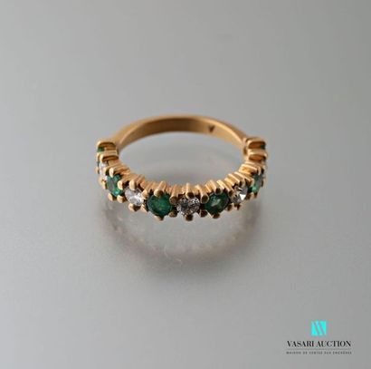 null Half-ring in 750 thousandths yellow gold set with six round emeralds alternating...