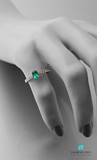 null 750 thousandths white gold ring set with an oval-cut emerald calibrating approximately...
