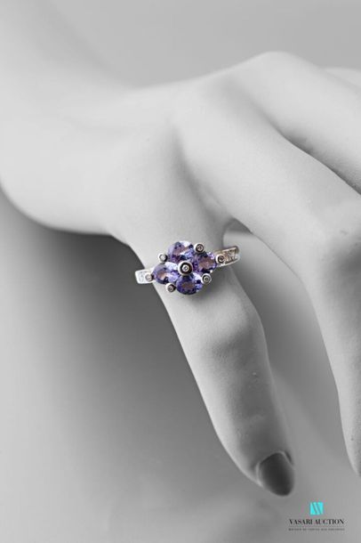 null 750 thousandths white gold ring set with four oval-shaped tanzanites interspersed...